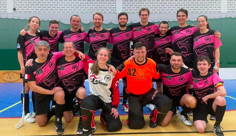 Die gemischte Mannschaft der Regensburger Panthers stellt sich vor einem Floorball Spiel zu einem Gruppenfoto auf.